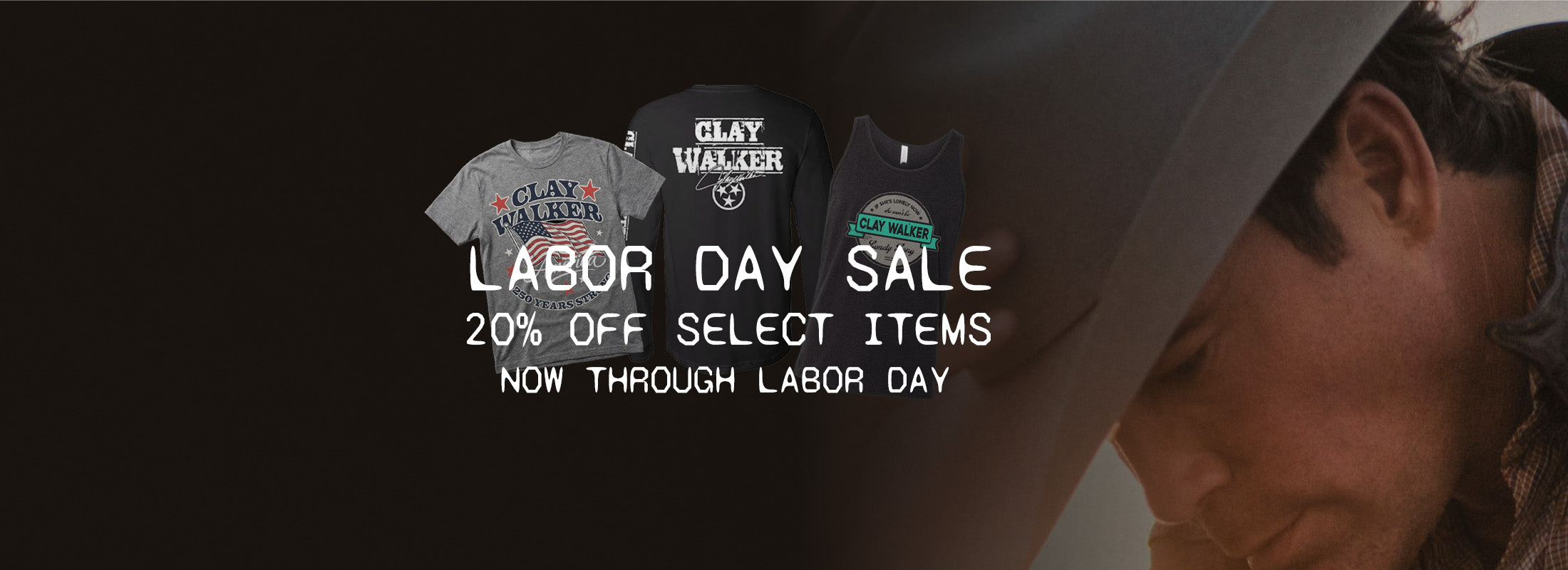 Promotional banner for a Labor Day Sale featuring three Clay Walker branded t-shirts (gray, black, and navy) with white text overlay reading 'LABOR DAY SALE 20% OFF SELECT ITEMS NOW THROUGH LABOR DAY' on a dark background with a partial side profile of a man.